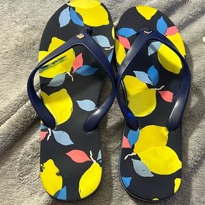 Kate Spade Navy flip flops with lemons printed on them